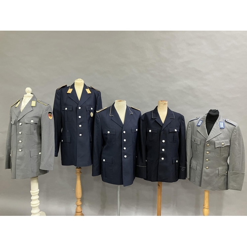 21 - Three West German Luftwaffe dark blue tunics and two army tunics, post war (5)