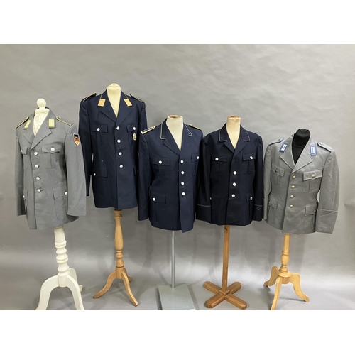 21 - Three West German Luftwaffe dark blue tunics and two army tunics, post war (5)