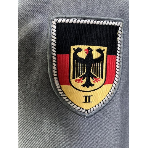 21 - Three West German Luftwaffe dark blue tunics and two army tunics, post war (5)