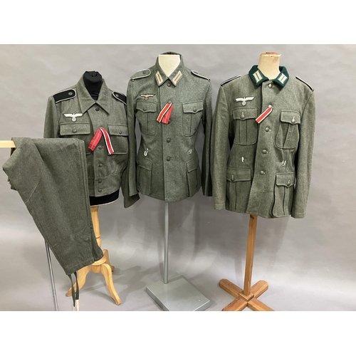 24 - A reproduction WWII style German battle dress blouse with Wesmachtsadler eagle and pair of trousers ... 