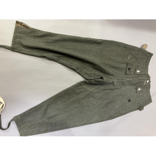 24 - A reproduction WWII style German battle dress blouse with Wesmachtsadler eagle and pair of trousers ... 