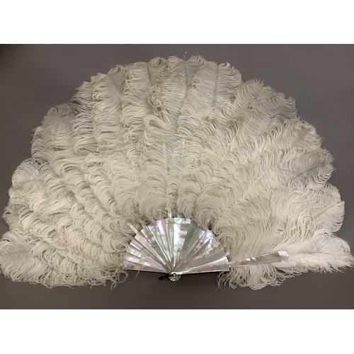 83 - A late 19th century white ostrich feather fan, the monture of pink/green burgau mother of pearl, wit... 