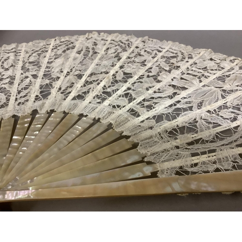 53 - Antique Lace: a c 1890’s Mixed Brussels lace fan, the monture of pink mother of pearl, the deep leaf... 