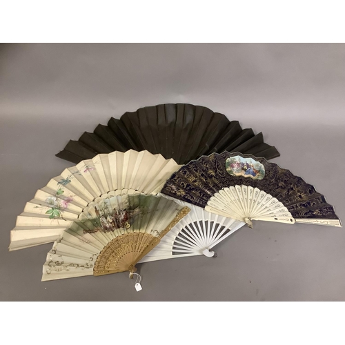 26 - A varied selection of 19th and 20th century fans, comprising a very large example with black wood mo... 