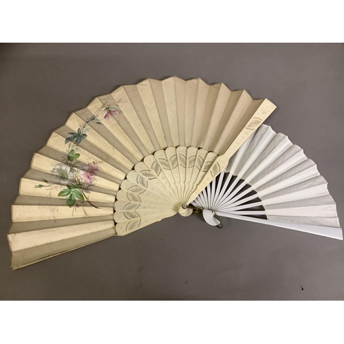 26 - A varied selection of 19th and 20th century fans, comprising a very large example with black wood mo... 