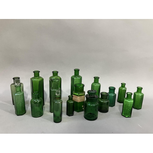 84 - A collection of sixteen green glass poison bottles, (two with stoppers) 7cm to 13.5cm high, one with... 