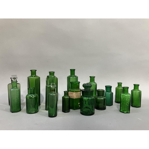 84 - A collection of sixteen green glass poison bottles, (two with stoppers) 7cm to 13.5cm high, one with... 