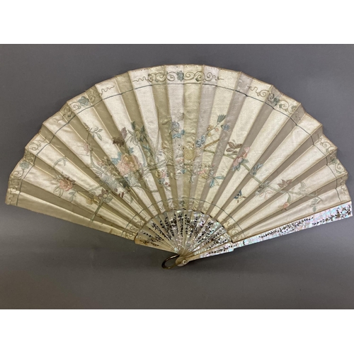 128 - A large fan, the monture of pink mother of pearl, gilded, the cream silk leaf Chinese, being embroid... 