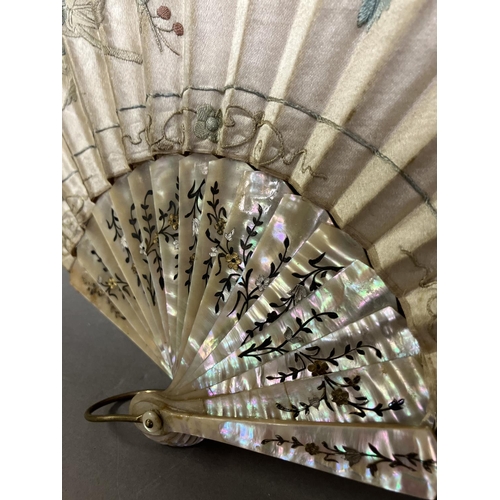 128 - A large fan, the monture of pink mother of pearl, gilded, the cream silk leaf Chinese, being embroid... 