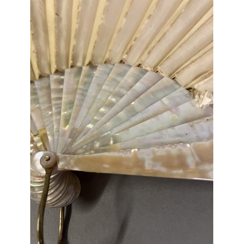 128 - A large fan, the monture of pink mother of pearl, gilded, the cream silk leaf Chinese, being embroid... 