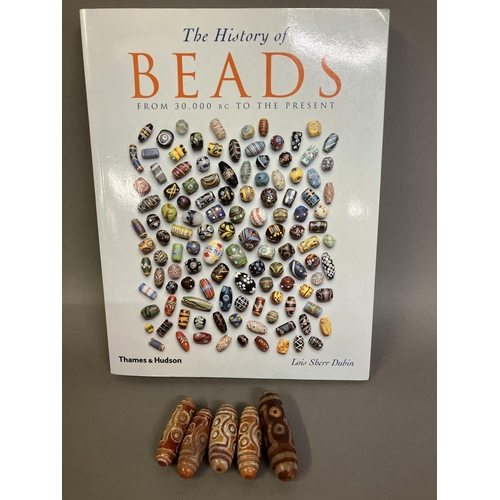 189 - Trade beads: Six large beads with eyes, four very similar with the work in relief and defined ridges... 