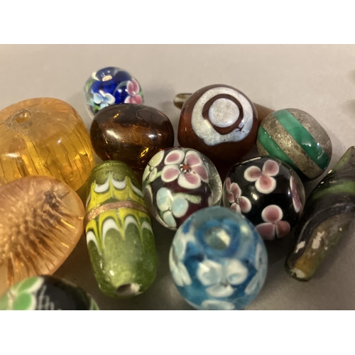 197 - Trade beads: a selection of glass beads, many with floral patterns, to include 10 in a deep yellow, ... 