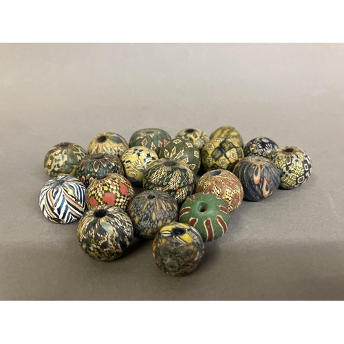 199 - Trade beads:  a selection of intricately pattered, medium round beads in mainly subtle colours (20) ... 