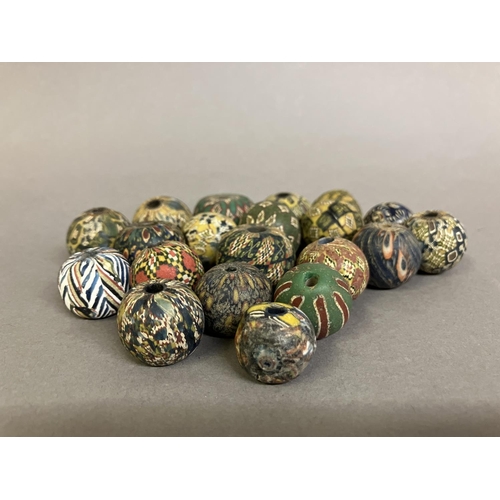 199 - Trade beads:  a selection of intricately pattered, medium round beads in mainly subtle colours (20) ... 