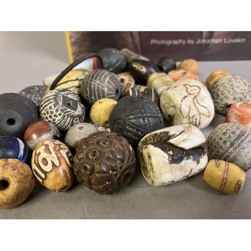 204 - Trade beads:  a good selection of beads, various sizes and shapes, many black or grey, carved, other... 