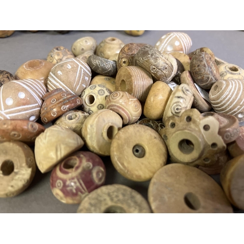 204 - Trade beads:  a good selection of beads, various sizes and shapes, many black or grey, carved, other... 