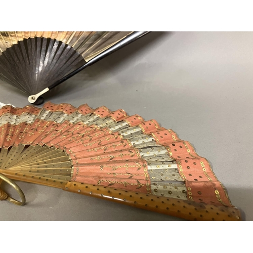 29 - A Regency engraved and coloured fan with double paper leaf, and slender wood monture with bone thumb... 