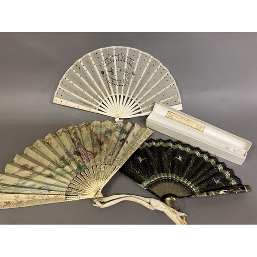 37 - An Art Nouveau fan, the monture of bone, shaped and gilded, the silk leaf painted with a lady in a s... 