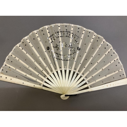 37 - An Art Nouveau fan, the monture of bone, shaped and gilded, the silk leaf painted with a lady in a s... 