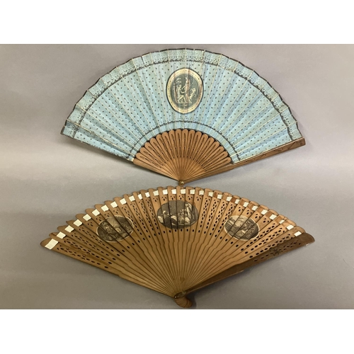 4 - Two late 18th century wood fans, the first a brisé with rounded tips, pierced, with applied cartouch... 