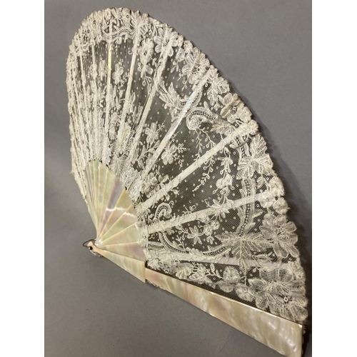 49 - A good Brussels lace fan, mounted on mother of pearl, burgau, including the ribs, the leaf most like... 