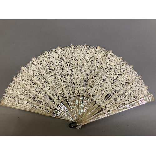 50 - Antique Lace: an early 20th century Maltese silk lace fan, the leaf mounted on pink mother of pearl ... 