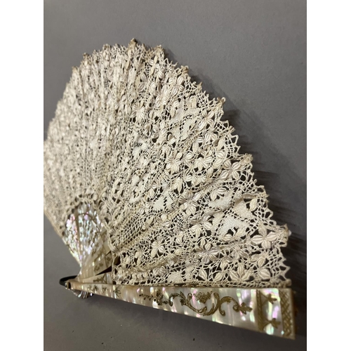 50 - Antique Lace: an early 20th century Maltese silk lace fan, the leaf mounted on pink mother of pearl ... 