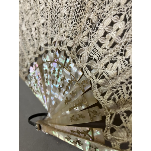 50 - Antique Lace: an early 20th century Maltese silk lace fan, the leaf mounted on pink mother of pearl ... 