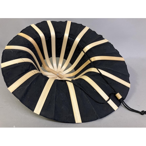 55 - Ann Collier; a shaped fan/sun shading hat, of the folding type easy to pack, the monture in light wo... 