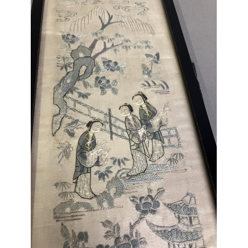 144 - A 19th century embroidered silk Chinese sleeve band, framed and glazed, the cream ground delicately ... 