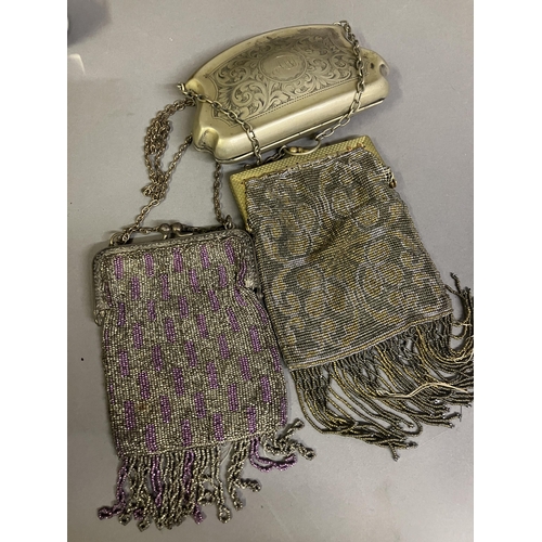 244 - A 19th century base metal purse with metal chain, etched with a scrolling design and initials to one... 