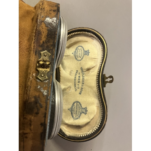 244 - A 19th century base metal purse with metal chain, etched with a scrolling design and initials to one... 