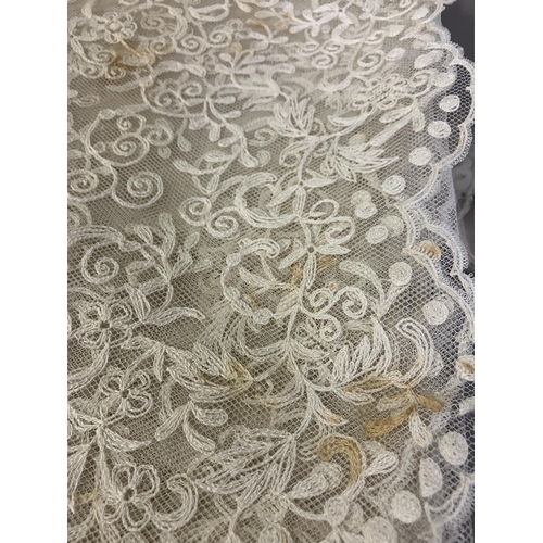 265 - A large embroidered net Edwardian wedding veil, the design creating deep borders and worked well int... 