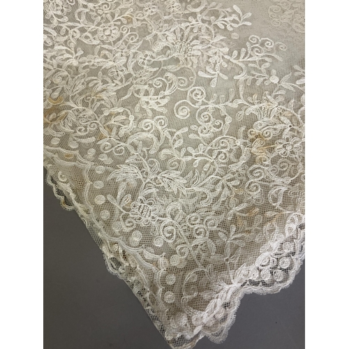 265 - A large embroidered net Edwardian wedding veil, the design creating deep borders and worked well int... 