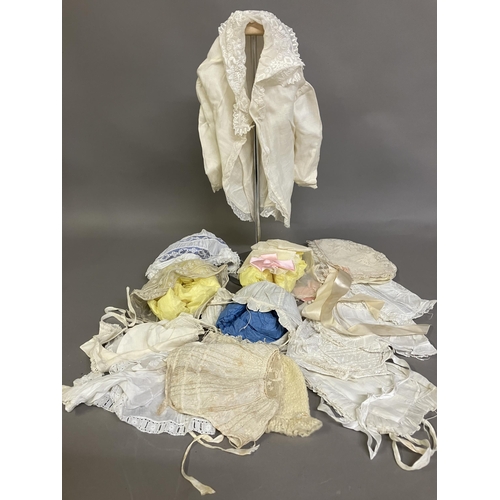 266 - A selection of antique baby bonnets, from plain with front frill to more elaborate with detail to th... 