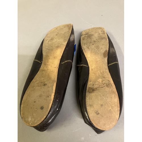 302 - A fine pair of French mid-19th century slippers, black glacé kid, edged with blue braid, square toes... 