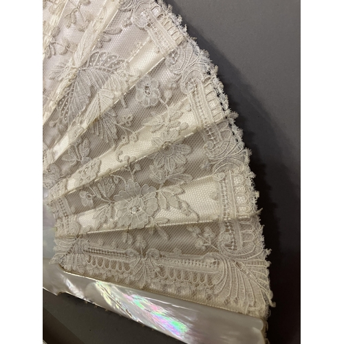 51 - A 19th century Brussels Bobbin Appliqué lace fan, the monture of white mother of pearl, the head sha... 