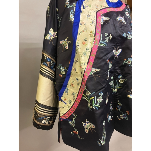 145 - An antique Chinese embroidered silk jacket. Ru, closure to the right, the body of the Ru embroidered... 