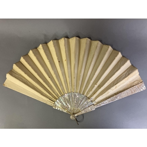 128 - A large fan, the monture of pink mother of pearl, gilded, the cream silk leaf Chinese, being embroid... 