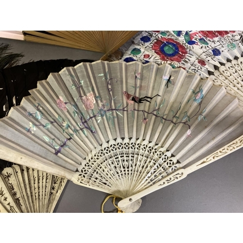 131 - Oriental fans: A selection of folding fans to include 3 Chinese feather fans mounted on pierced bone... 