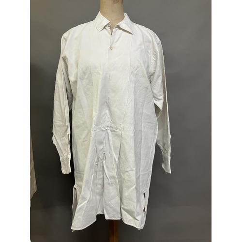 304 - Two mid-19th century rustic gentlemen’s shirts, both heavy linen, from a farming family, with droppe... 