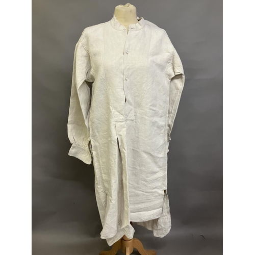 305 - A mid-19th century gentleman’s nightshirt, French, exceptionally long, heavy linen, with a short, un... 