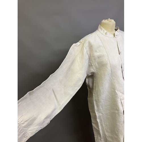 305 - A mid-19th century gentleman’s nightshirt, French, exceptionally long, heavy linen, with a short, un... 