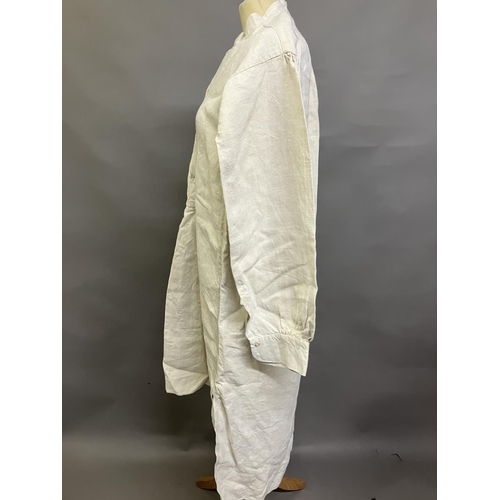 305 - A mid-19th century gentleman’s nightshirt, French, exceptionally long, heavy linen, with a short, un... 