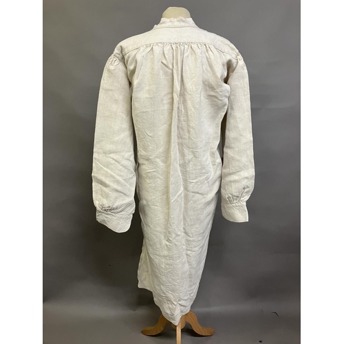 305 - A mid-19th century gentleman’s nightshirt, French, exceptionally long, heavy linen, with a short, un... 