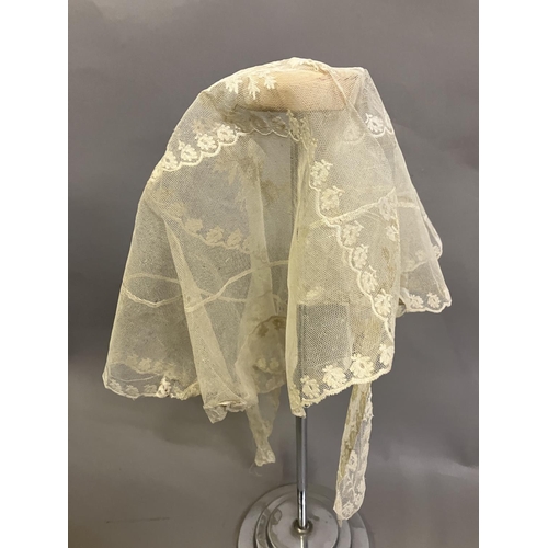 308 - Antique lace: a bonnet veil in cream embroidered net, foliate design; two other hat veils in net, on... 