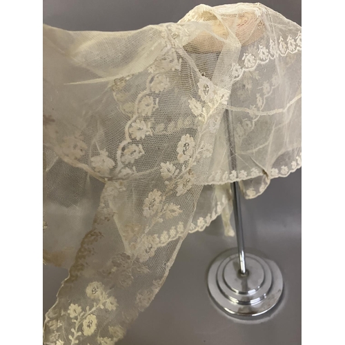 308 - Antique lace: a bonnet veil in cream embroidered net, foliate design; two other hat veils in net, on... 