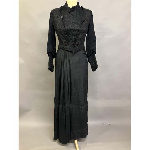 323 - Two Edwardian bodices and a skirt, all in black, none matching, the first bodice in a heavy black cr... 