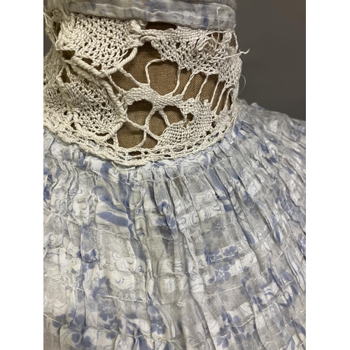 324 - An Edwardian summer two-piece ensemble, c 1903, in printed cotton, pale blue flowers and leaves on a... 