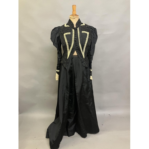 325 - A c 1890’s/900 black silk two-piece ensemble, the tailored bodice with gathers to the shoulder and s... 